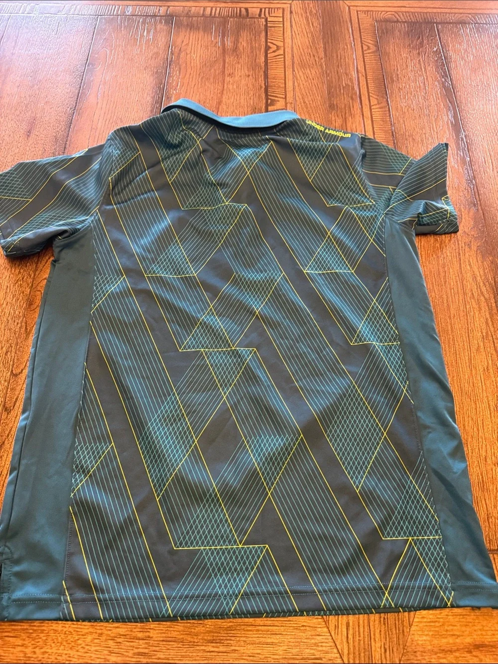 Under Armour Boys Black Polo with Yellow Logo and Teal Geometric Lines